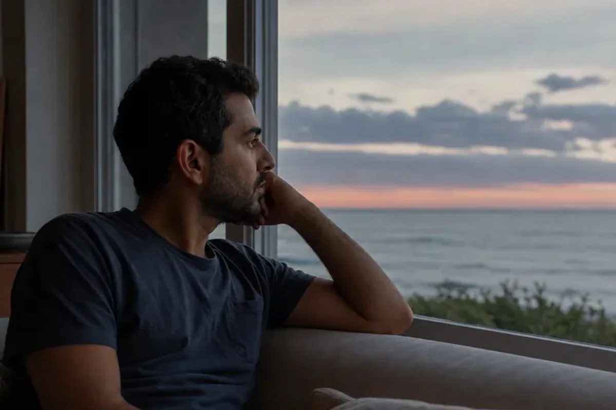 A person looking across a wide, misty landscape from a safe overlook at early morning.